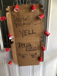 a cardboard sign with red cups attached to it that says dobblel broken yell ding don't really loud