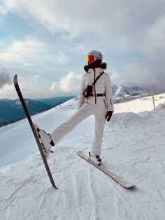 a person riding skis on top of a snow covered slope