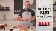 a man standing in front of a cutting board with raw meat on it and the words short ribs with wayne lewis beef