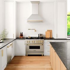 a kitchen with an oven, stove and counter tops in white painted wood flooring