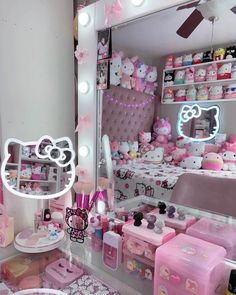 a hello kitty themed bedroom is shown with pink accessories on the bed and in the mirror