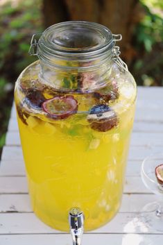 a jar filled with liquid sitting on top of a wooden table