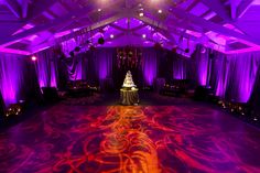 a large room with purple lighting and decorations