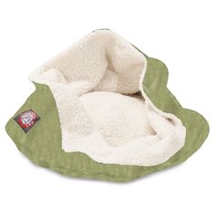 a green and white dog bed with a stuffed animal inside