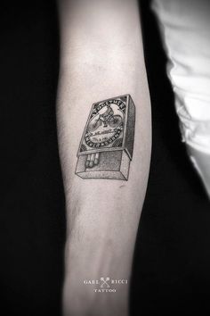 a tattoo on the arm of a man with a clock and skull in it's box