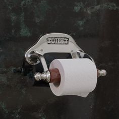 a toilet paper dispenser with two rolls of toilet paper hanging from it's holder