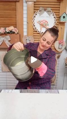 a woman is pouring something into a cup