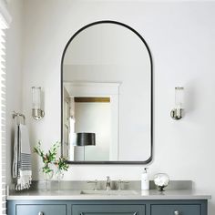 a bathroom vanity with a large mirror above it