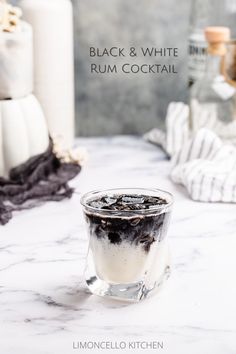 creamy white cocktail in an old fashioned glass with a layer of black on top White And Black Cocktail, Black And White Drinks Cocktails, Cow Themed Cocktails, Black Liquor Drinks, Black And White Appetizers, Black Rum Cocktails, Black Mixed Drinks, Oreo Cocktail, Black Drinks Cocktails