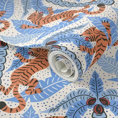 a close up view of a blue and orange wallpaper with tiger designs on it