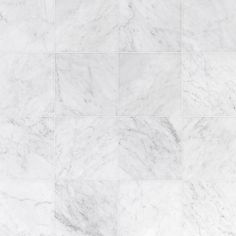 a white marble tile wall that looks like it could be used as a floor covering