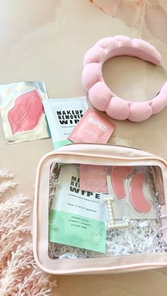 the contents of a beauty box are laid out on top of each other, including a pink headband