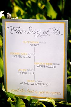 a sign that says the story of us is posted in front of some green leaves