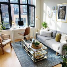 a living room filled with furniture and lots of windows next to a window sill