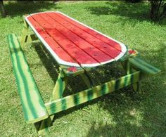 a picnic table made out of an old watermelon and painted with green stripes