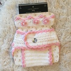 a crocheted diaper is laying on a white carpet with a tag attached to it