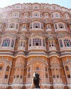 a tall building with many windows and balconies