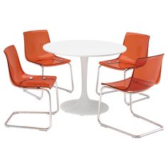 three orange chairs around a white table