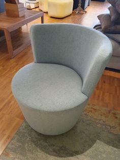 a blue chair sitting on top of a wooden floor