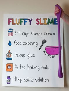 a child's hand holding up a sign that says fluffy slime