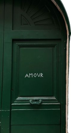 an open green door with the word amovr written on it