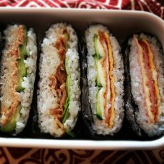 several sushi rolls in a white dish on a table