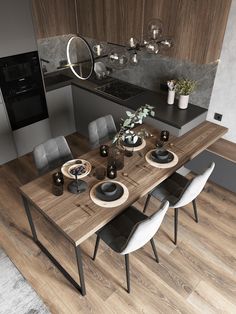 a dining table with chairs and plates on it in the middle of a wooden floor