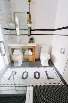 a bathroom with black and white tile flooring