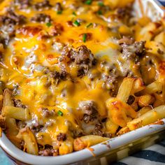 a casserole dish filled with cheese and meat