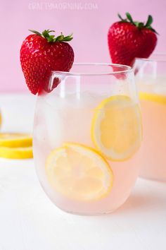 two glasses filled with lemonade and strawberries