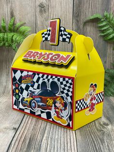 a yellow box with mickey mouse's race car on it and the number one