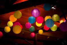 colorful paper lanterns are hanging from the ceiling