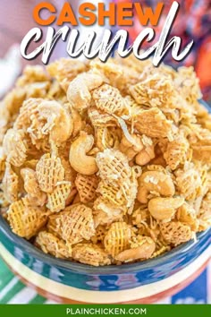 a bowl filled with cashew crunch cereal on top of a colorful table cloth and the words cashew crunch above it