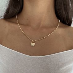 Our Valentina Heart Necklace is the sweetest statement necklace. Layer with other necklaces to elevate your look! Product Details: 14k Gold Filled Large Ball Chain Gold Filled Puffy Heart Charm 16" & 18" in Length Made in USA Expensive Necklaces, Puffy Heart Necklace, Puffy Heart Charms, Heart Pendant Gold, Puffed Heart, Girly Accessories, Gold Heart Necklace, Puffy Heart, School Fits