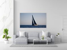 a sailboat floating in the ocean on a sunny day