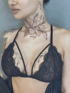 a woman with tattoos on her neck and chest