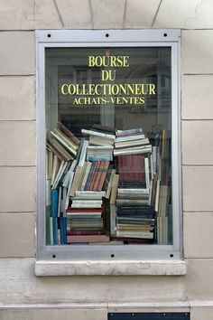 a bunch of books that are in a window