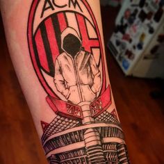 a man's arm with a tattoo on it that reads acm and has an image of a soccer player