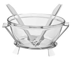 a glass bowl with two spoons and tongs in the bottom, on a white background