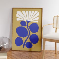 a blue and white flower on a yellow background next to a chair in a room