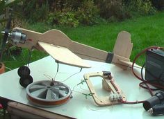 a camera and some electronics sitting on top of a table in front of green grass