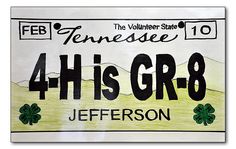 a license plate for jefferson, tennessee with four leaf clovers on the front and back