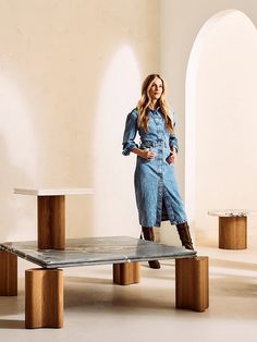 a woman standing on top of a wooden table