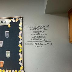 a bulletin board with words written on it next to a wall mounted art piece that reads, you're not choose me who you are