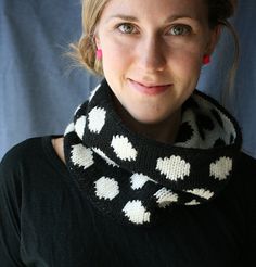 a woman is wearing a black and white cowgirl neck scarf with hearts on it