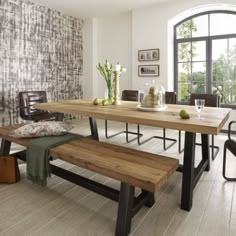 a dining room table with two benches in front of it