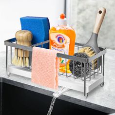 a kitchen sink with soap, sponges, and other cleaning products in the holder