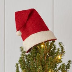 a small christmas tree with a santa hat on top