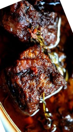 two pieces of meat sitting on top of a white plate