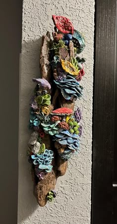 This very unique wall decor is handmade and  one-of-a-kind! As you can see, I love creating mushrooms from earthenware clay and having them attached to real driftwood that I have found.  It makes a really  cool piece of wall art for that special place in your home. I carefully make each individual mushroom by hand, with lots of detail. When the clay is dry, it is ready to be fired.  Next step is to glaze all the colors on each mushroom.  Now time to fire them a second time. Each piece is then glued on the driftwood.  I use a very strong glue that has never failed me.  Last step is to add the wire and screws for hanging, All it takes is one nail to hang...really easy and trustworthy. measures  18" tall and 6" across at the widest. free shipping Driftwood Projects Unique, Cool Clay Ideas, Pottery Mushrooms, Kids Art Class Ideas, Forest Diy, Clay Mosaic, Mushroom Theme, Driftwood Art Sculpture, Clay Mushrooms